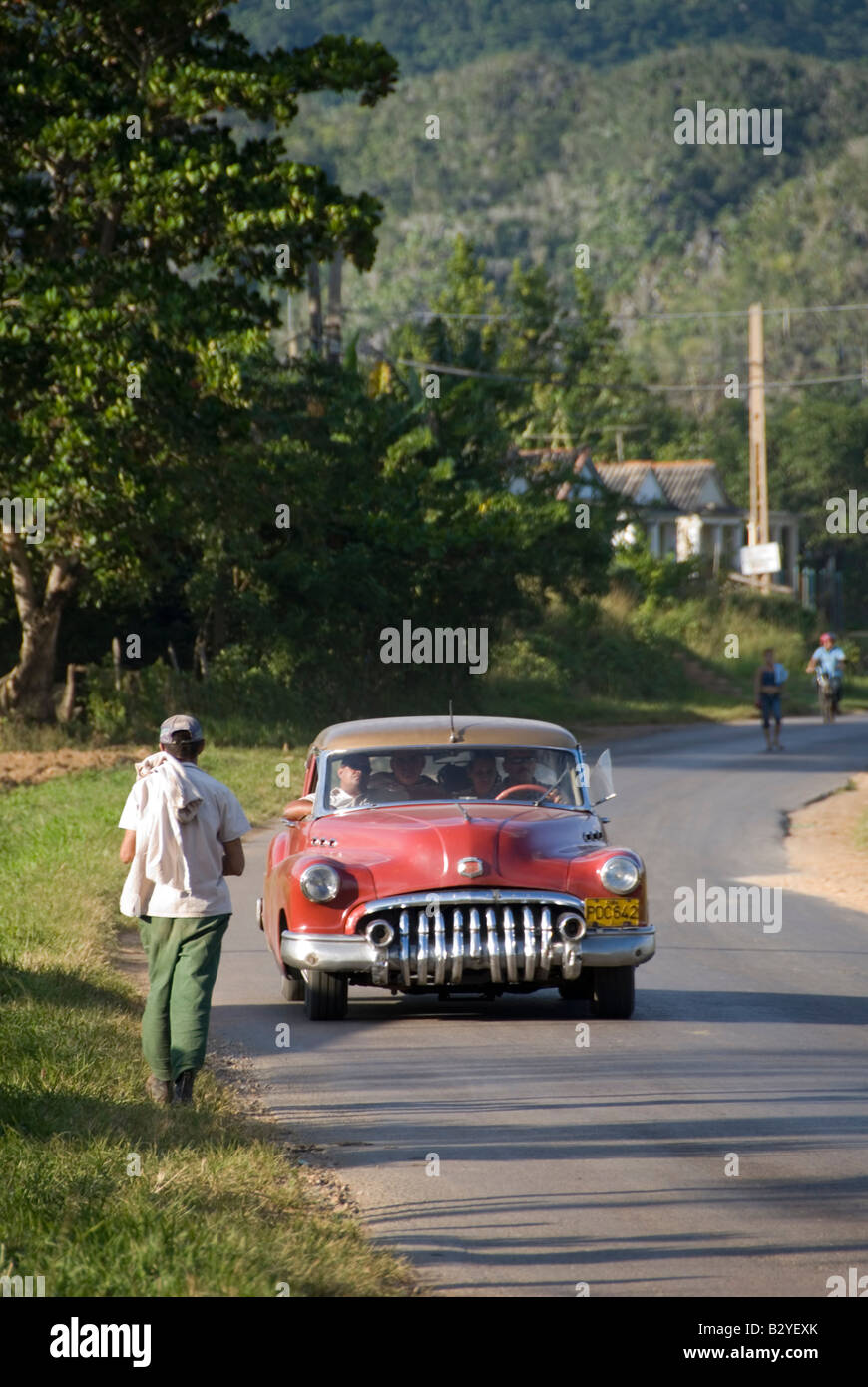 Classic vintage American 1950 s car travelling along a country road in Vinales Cuba Stock Photo