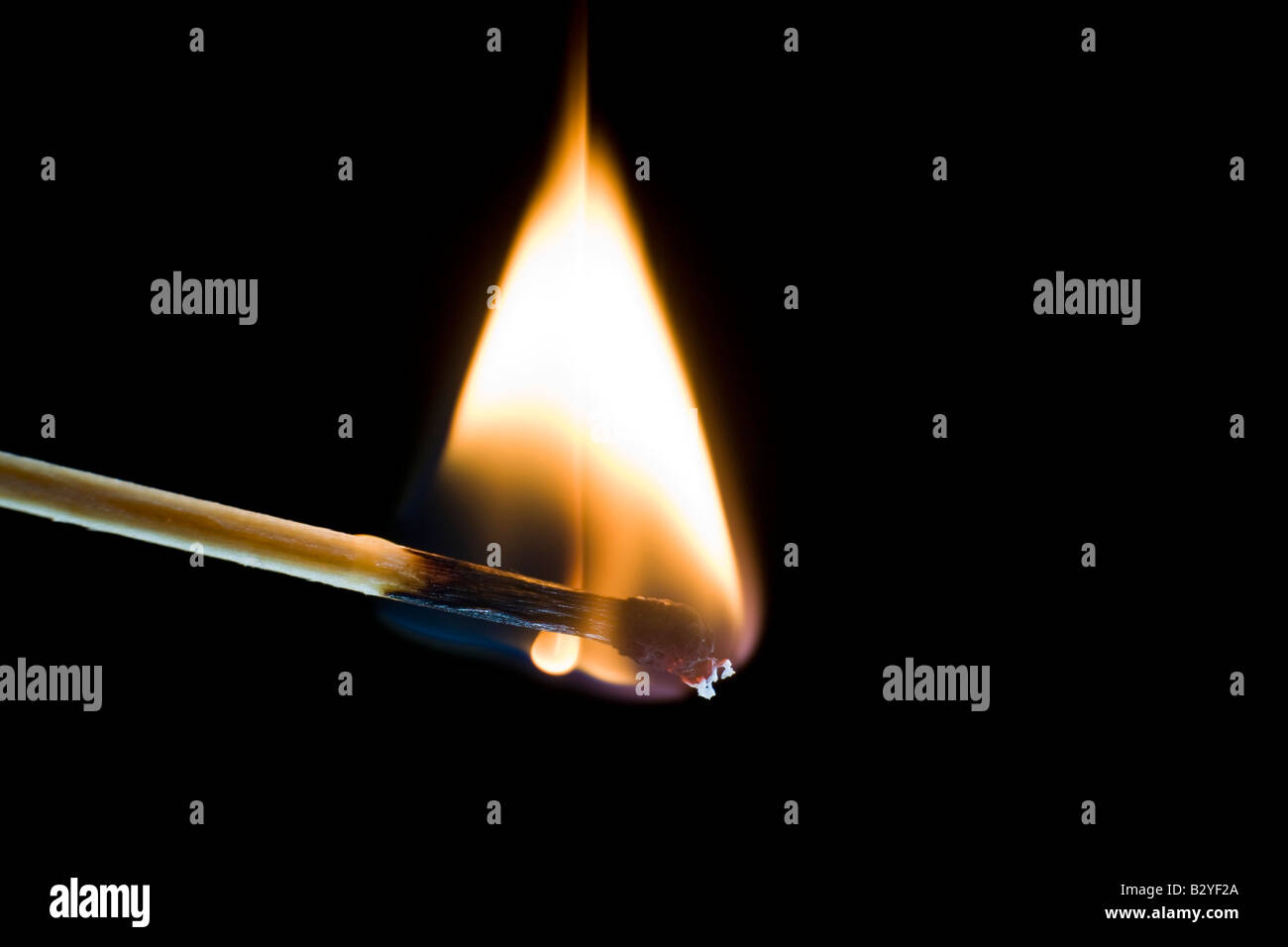 Macro shot of a burning match against a black background Stock Photo