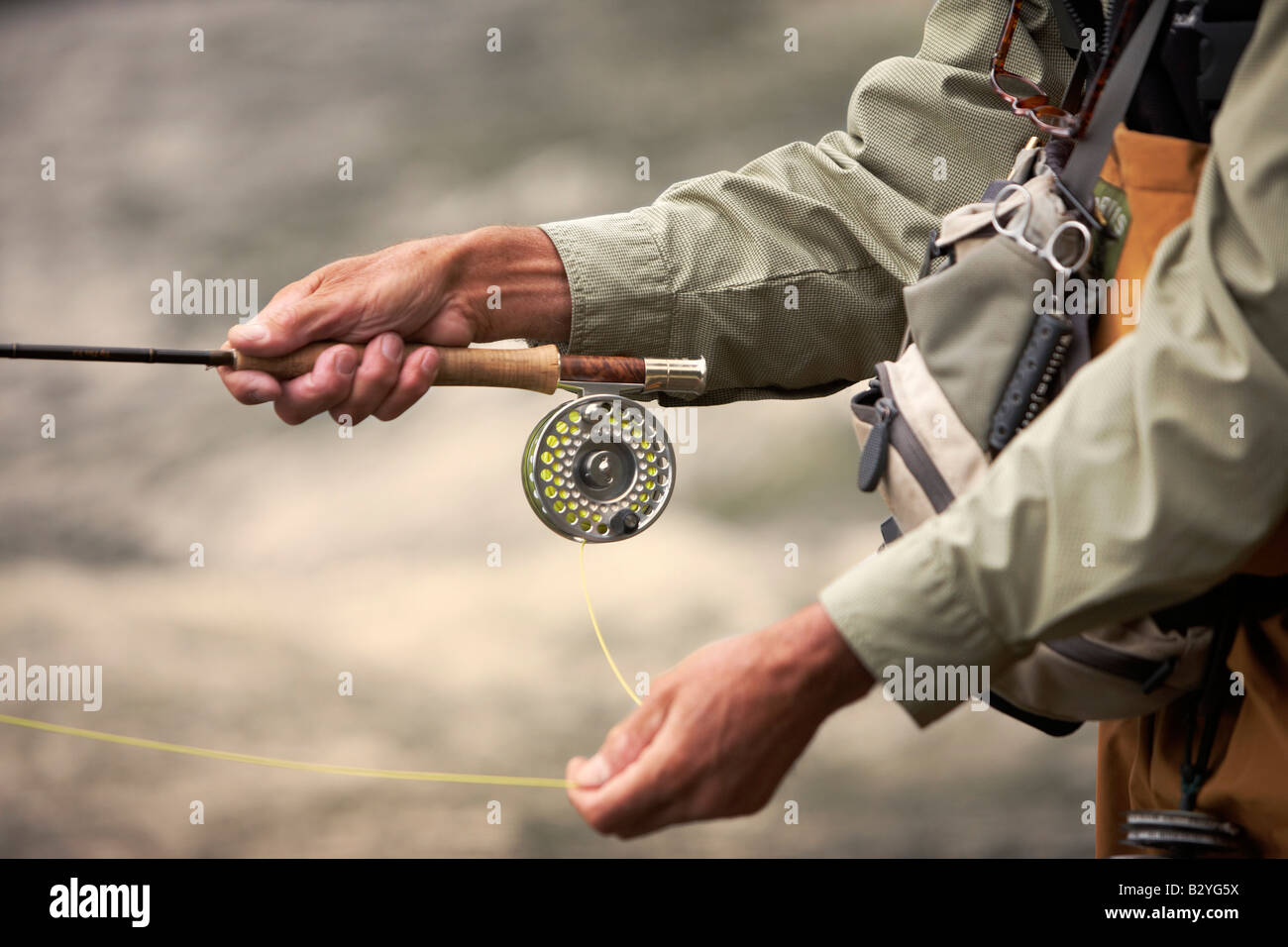Close up side view of a fly fisherman casting. Stock Photo
