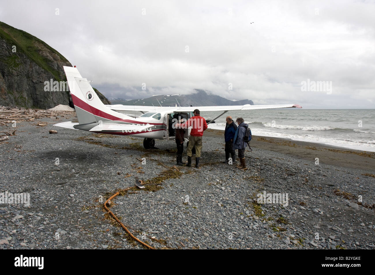 Tourists boarding a small Cessna airplane on a beach in Katmai National Park & Preserve, Alaska. Stock Photo