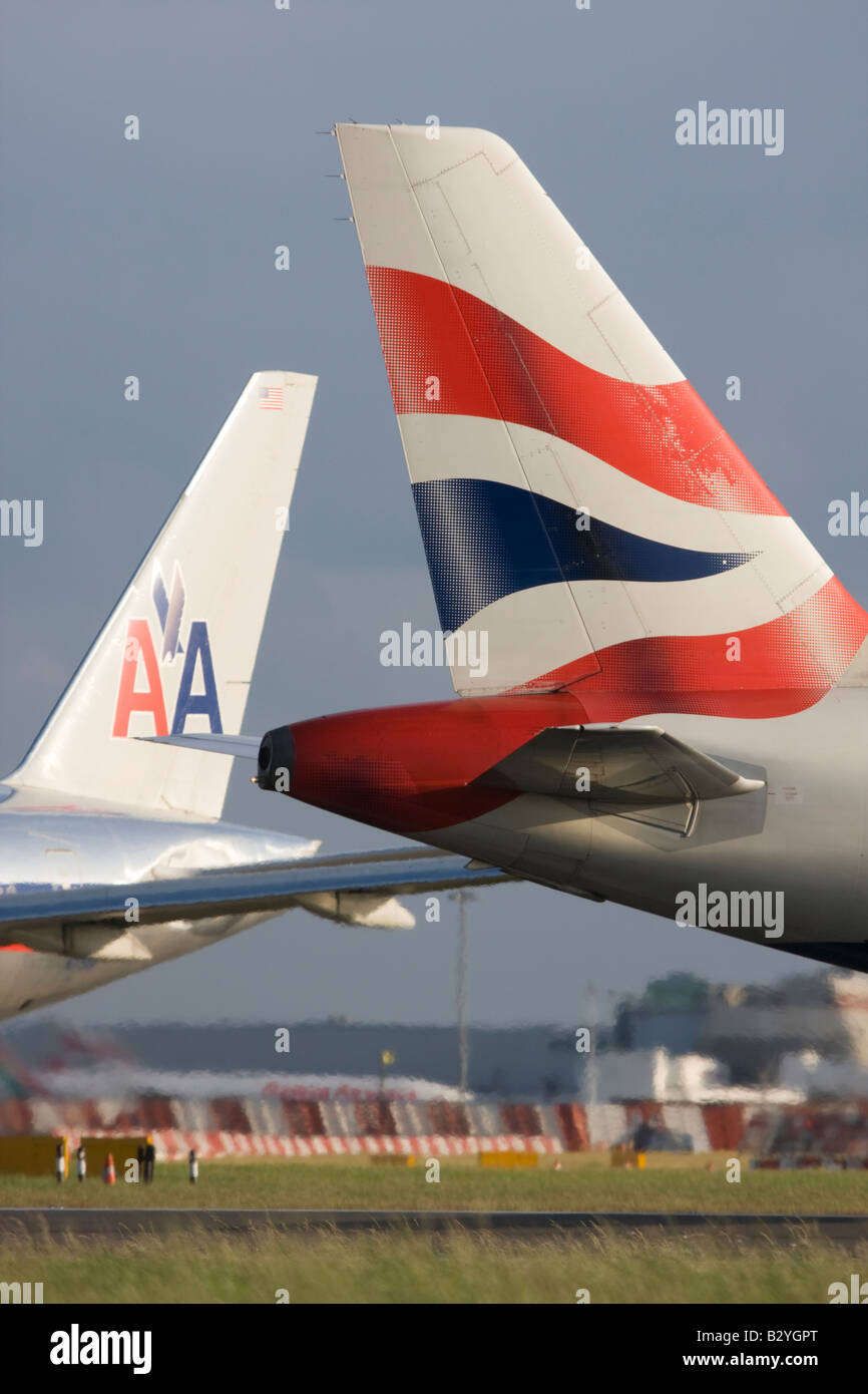 The tails of British Airways and American Airlines planes - London Heathrow, United Kingdom Stock Photo