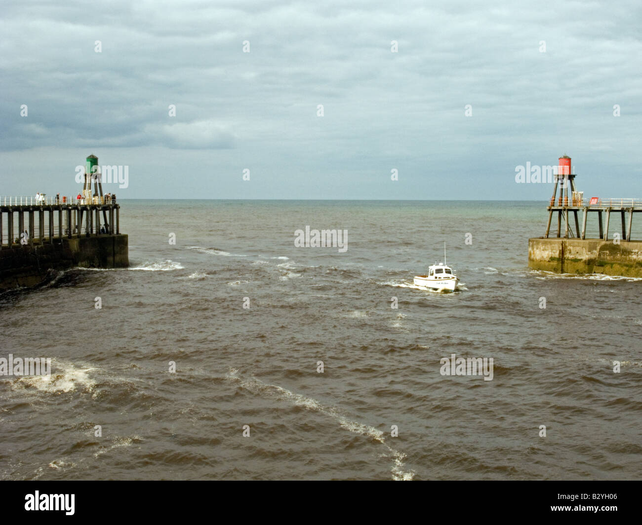 Boat entering Whitby harbour Stock Photo - Alamy