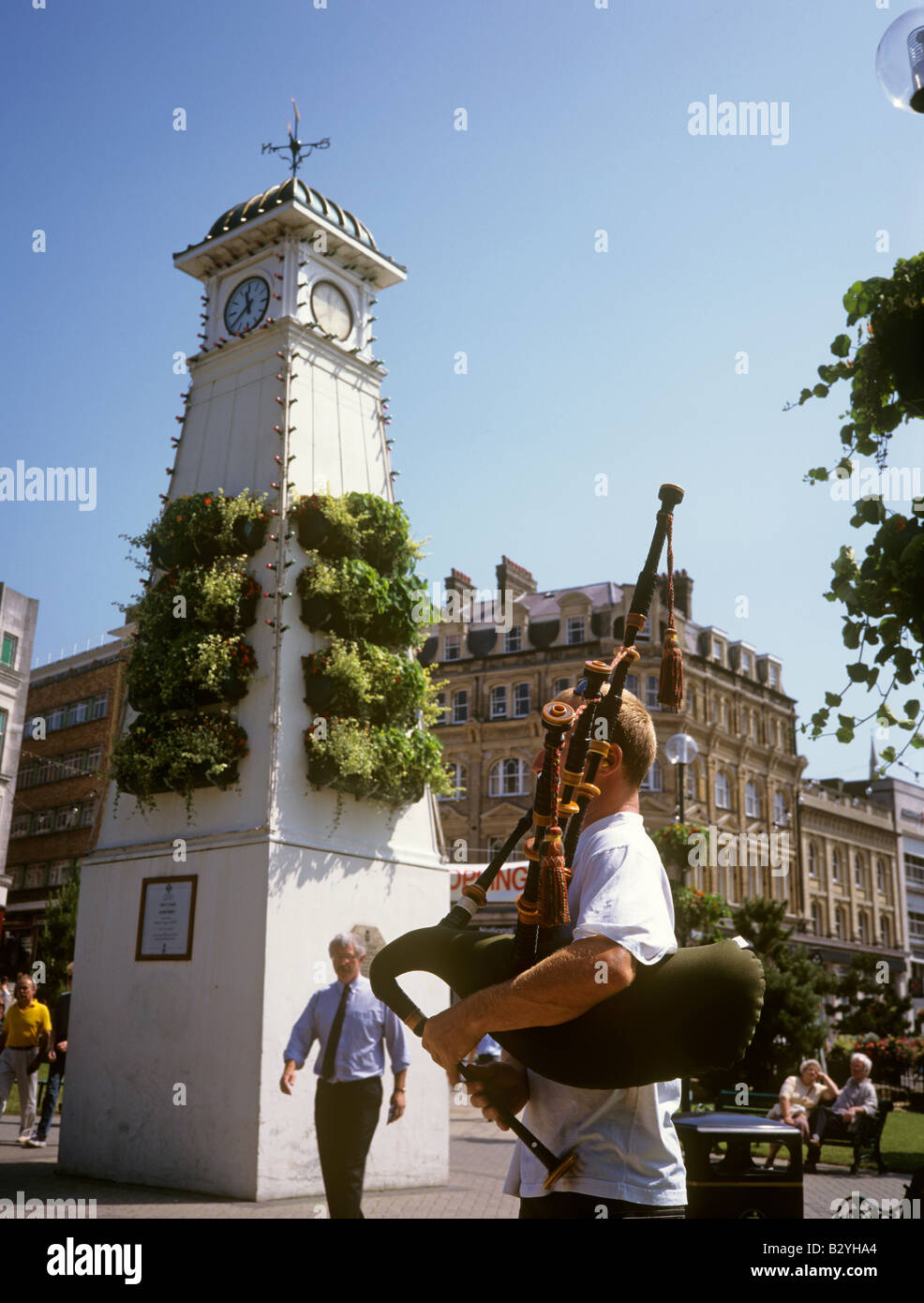 UK England Dorset Bournemouth busker playing bagpipes in the square Stock Photo