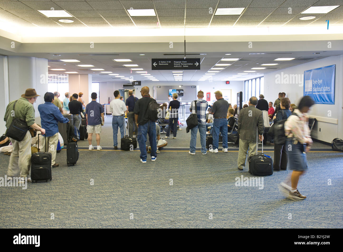 People wait in the lobby (waiting room) and prepare to board the ...