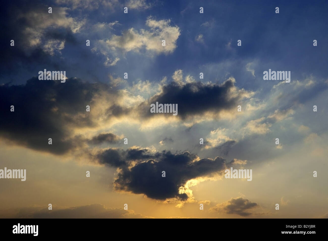 A cloudscape in the sky with clouds and shafts of light Stock Photo - Alamy