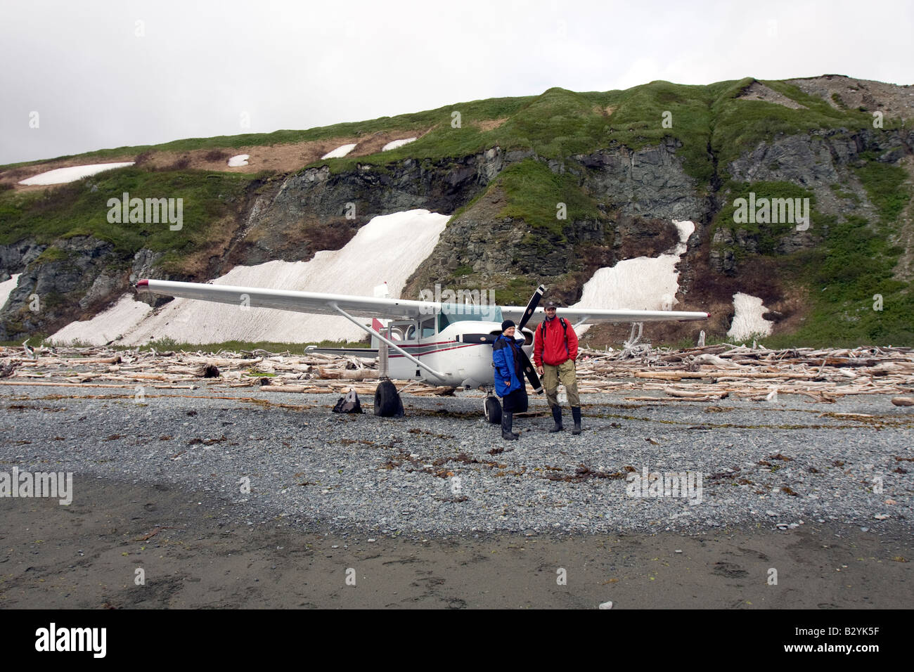 Tourist before a smal airplane on a beach in Katmai National Park & Preserve, Alaska. Stock Photo
