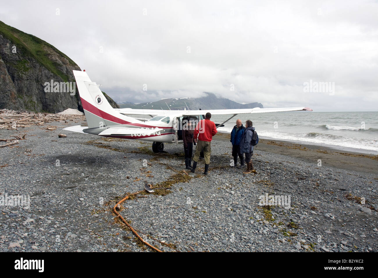 Tourists boarding a small airplane on a beach in Katmai National Park & Preserve, Alaska. Stock Photo