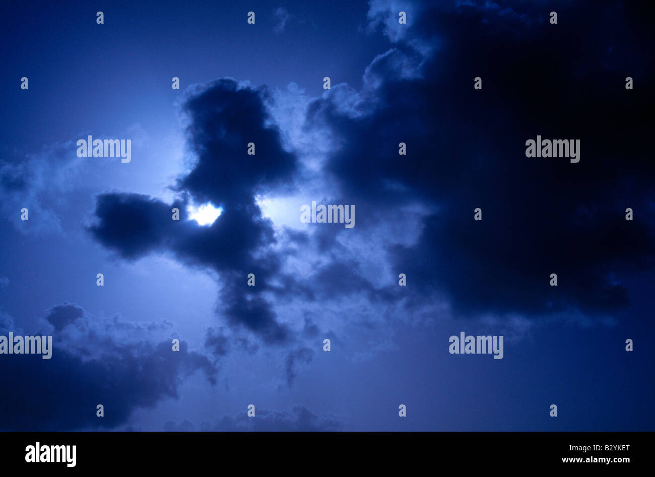 Blue Stormy Sky With Sun Stock Photo - Alamy