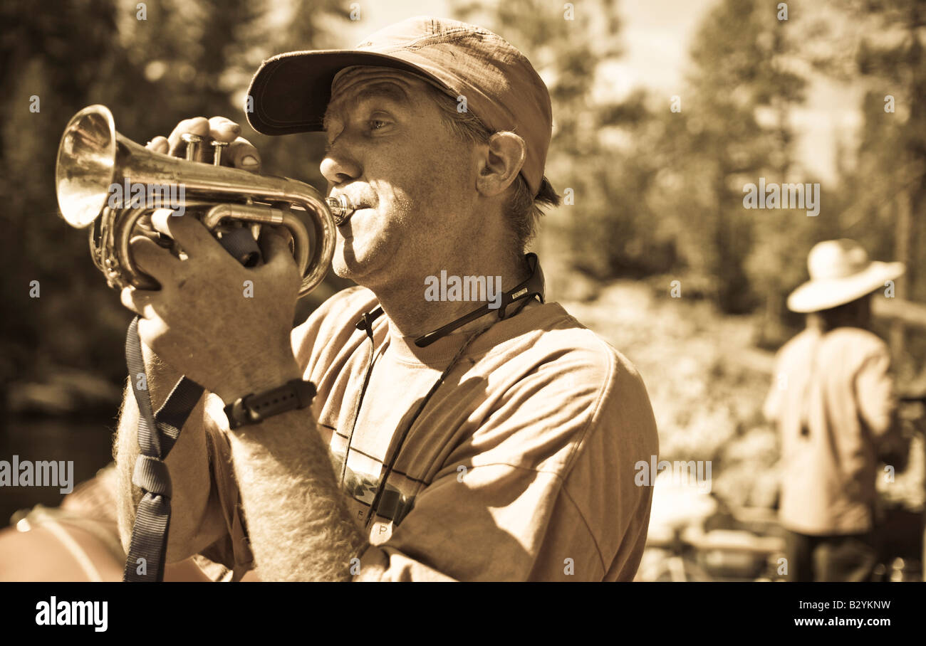 Idaho, Middle Fork of the Salmon River. A river guide plying his trumpet.. Stock Photo