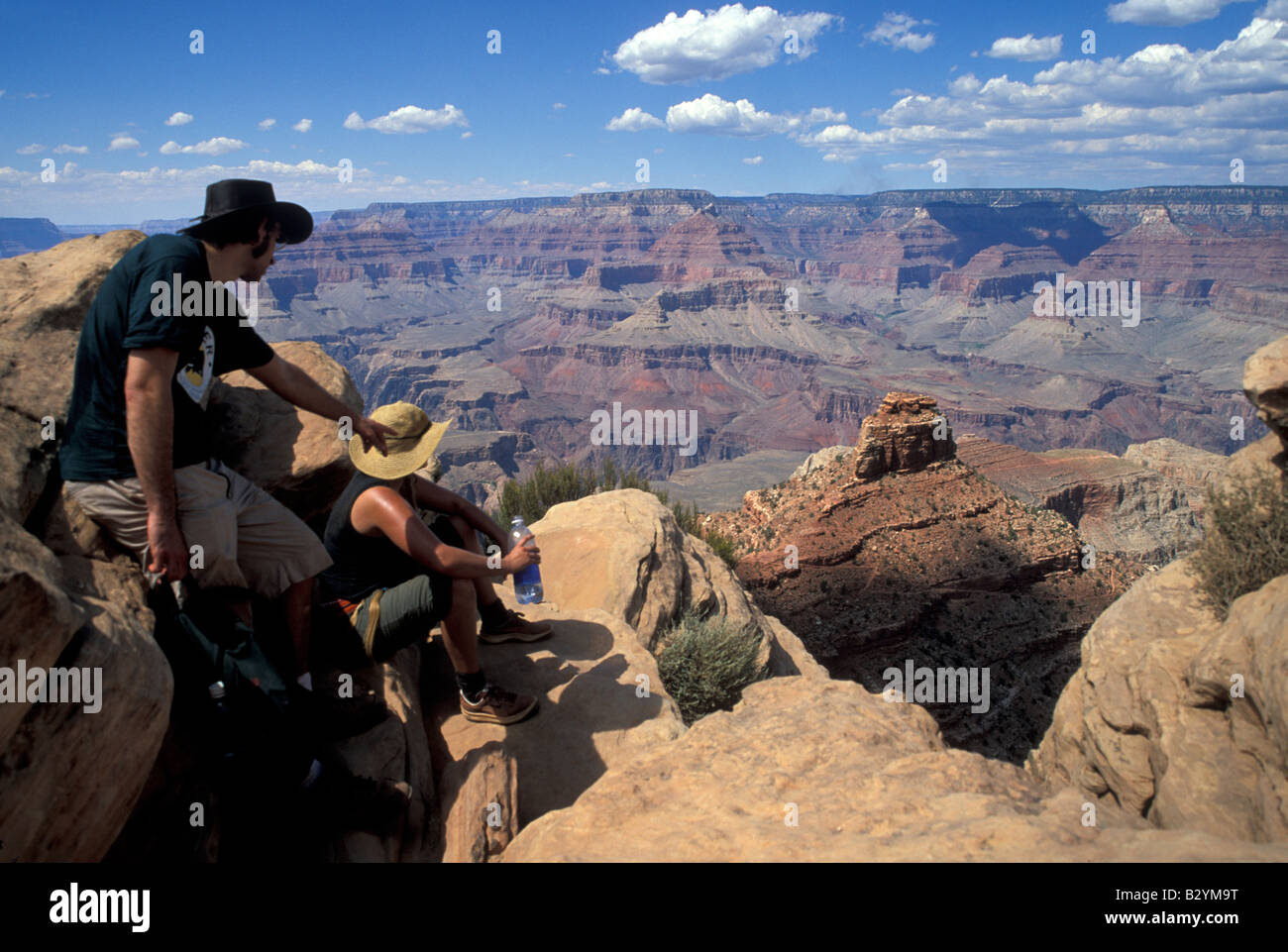Two hikers rest at the Ooh Aah Point of South Kaibab Trail in the Grand Canyon Stock Photo