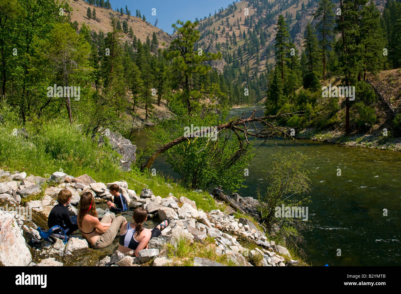 Idaho, Middle Fork of the Salmon River. A group of people sit in a hot pool from a hot springs
