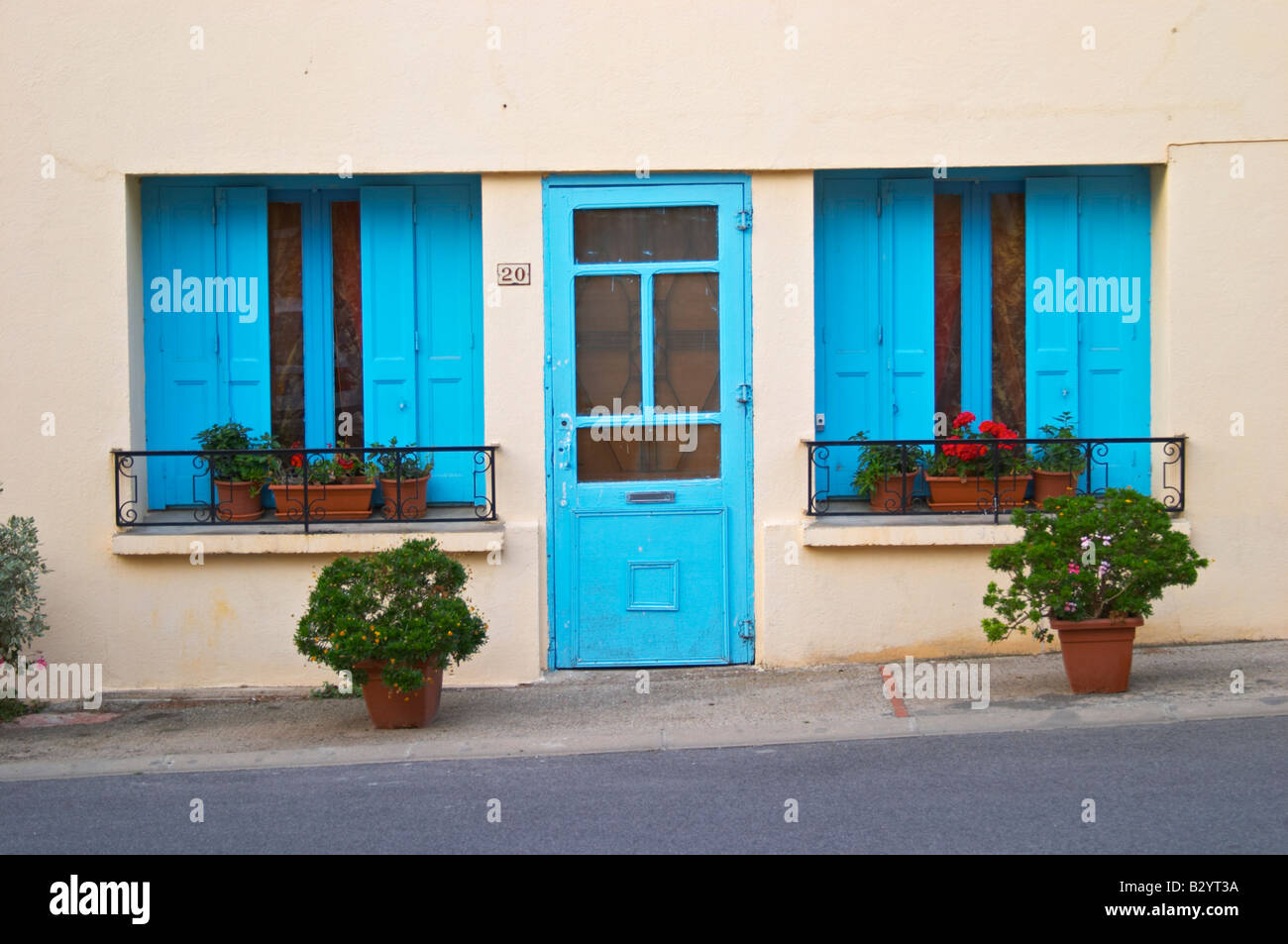 Village house with blue door and window shutters. Caramany, Ariege ...