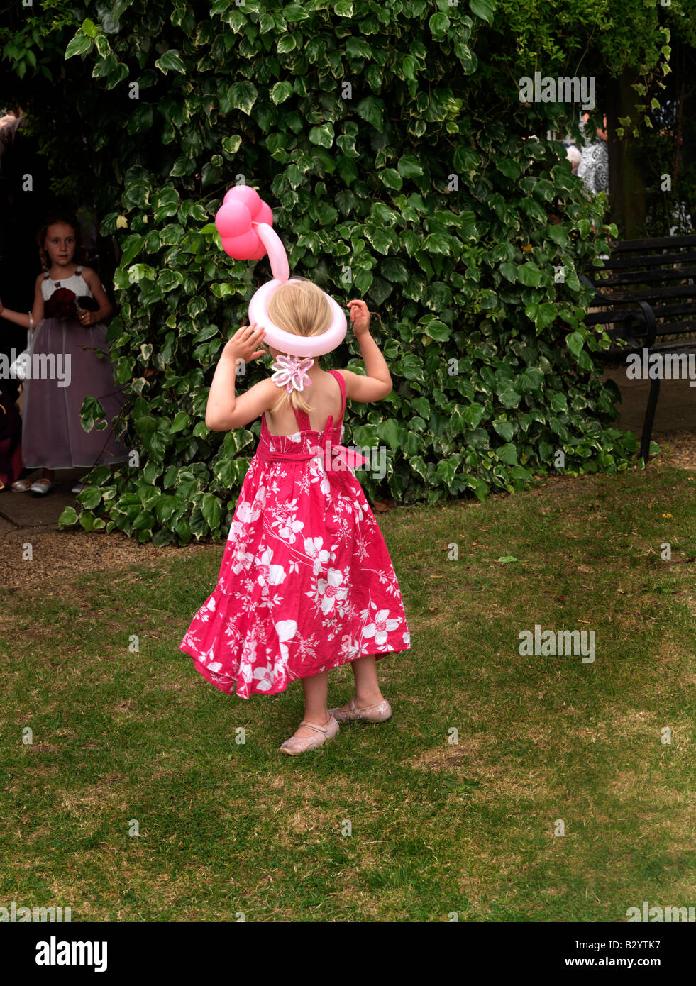 Hide and Seek at a Wedding wearing a Balloon Hat with Flower Stock Photo