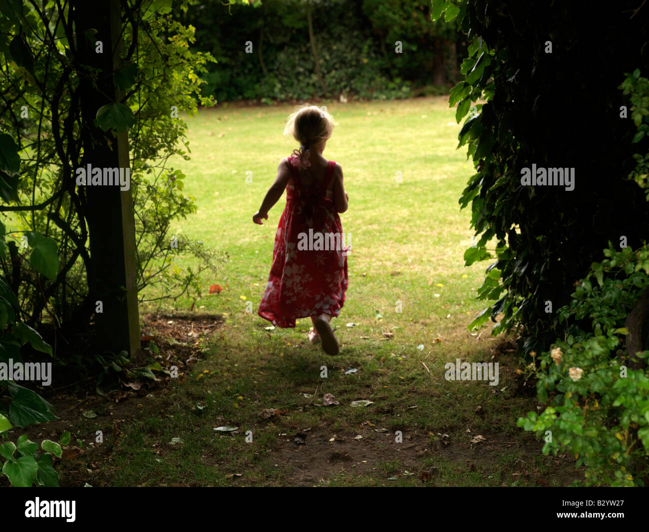 Child Walking into a Garden Stock Photo