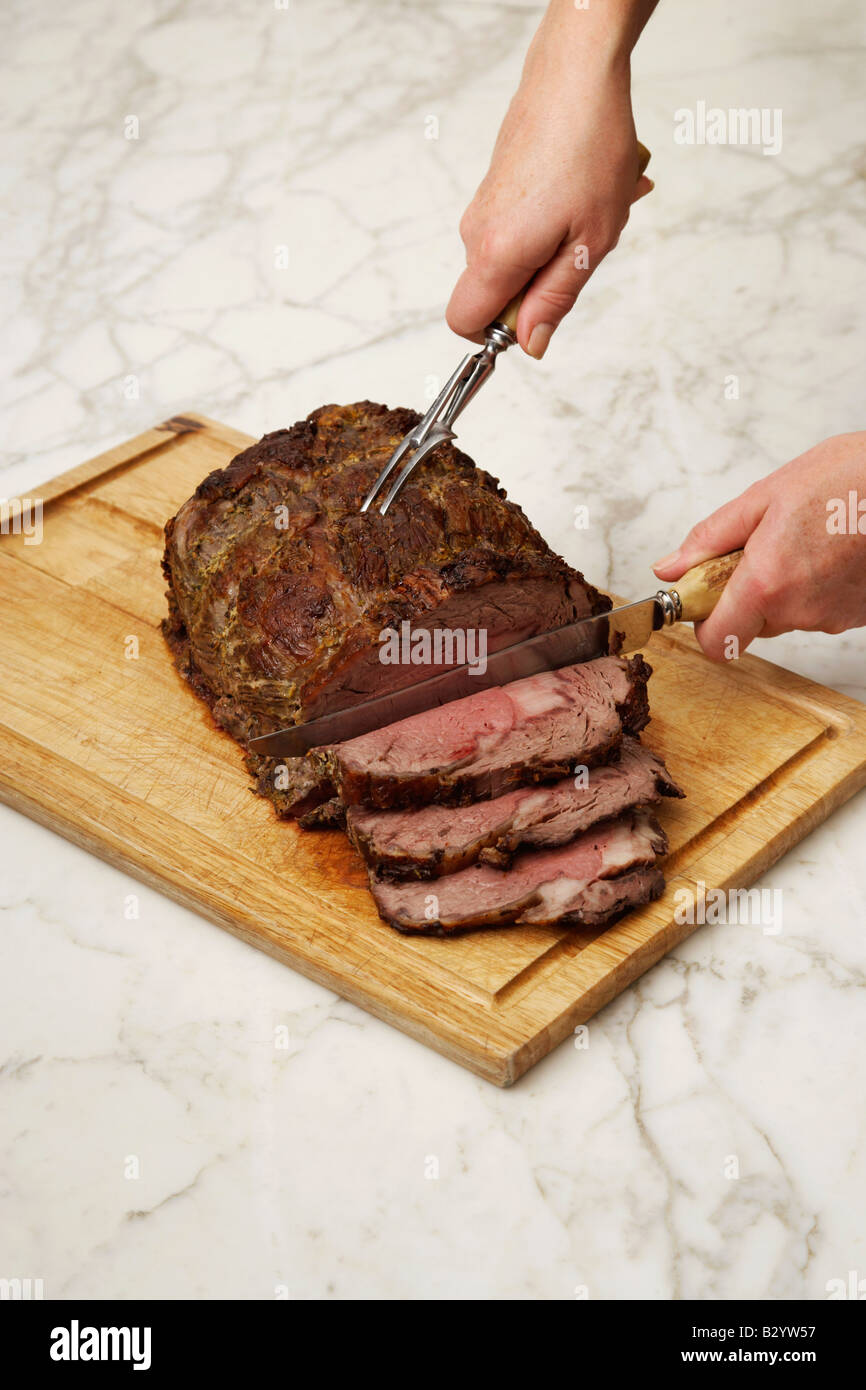 Hands Carving Roast Beef Stock Photo Alamy