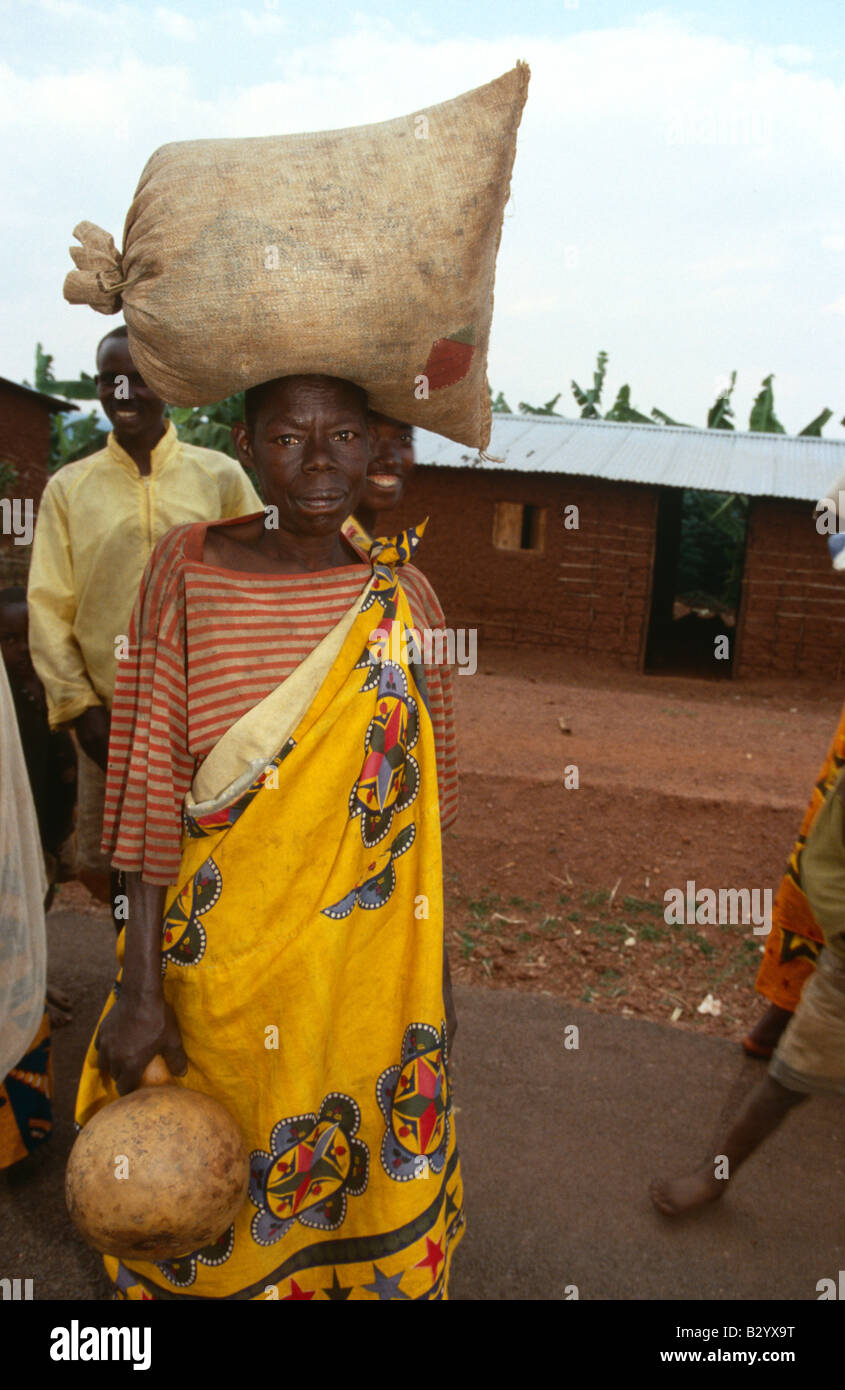 Woman carrying sacks of distributed food on head, Burundi Stock Photo