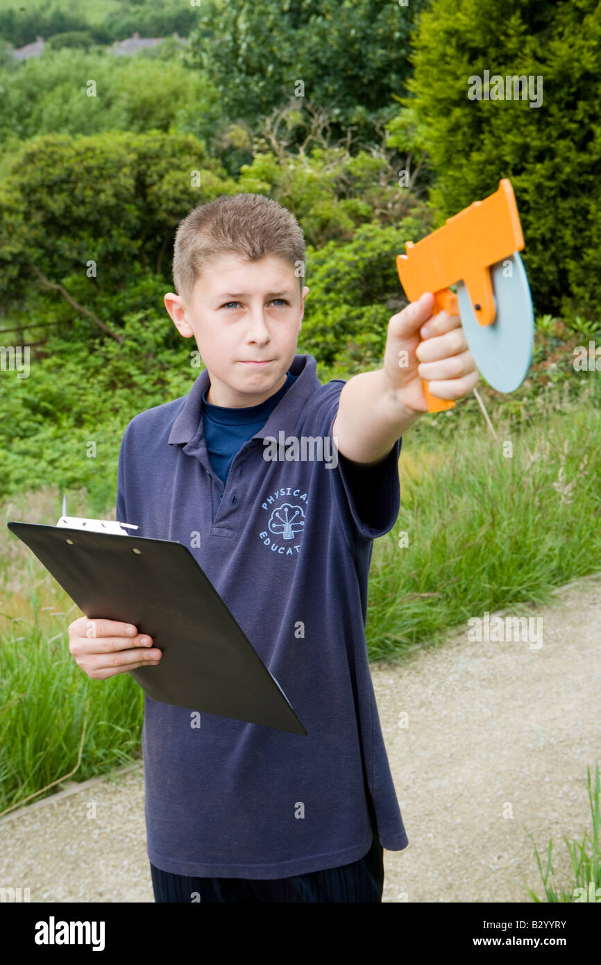 boy measuring the height of a tree Stock Photo