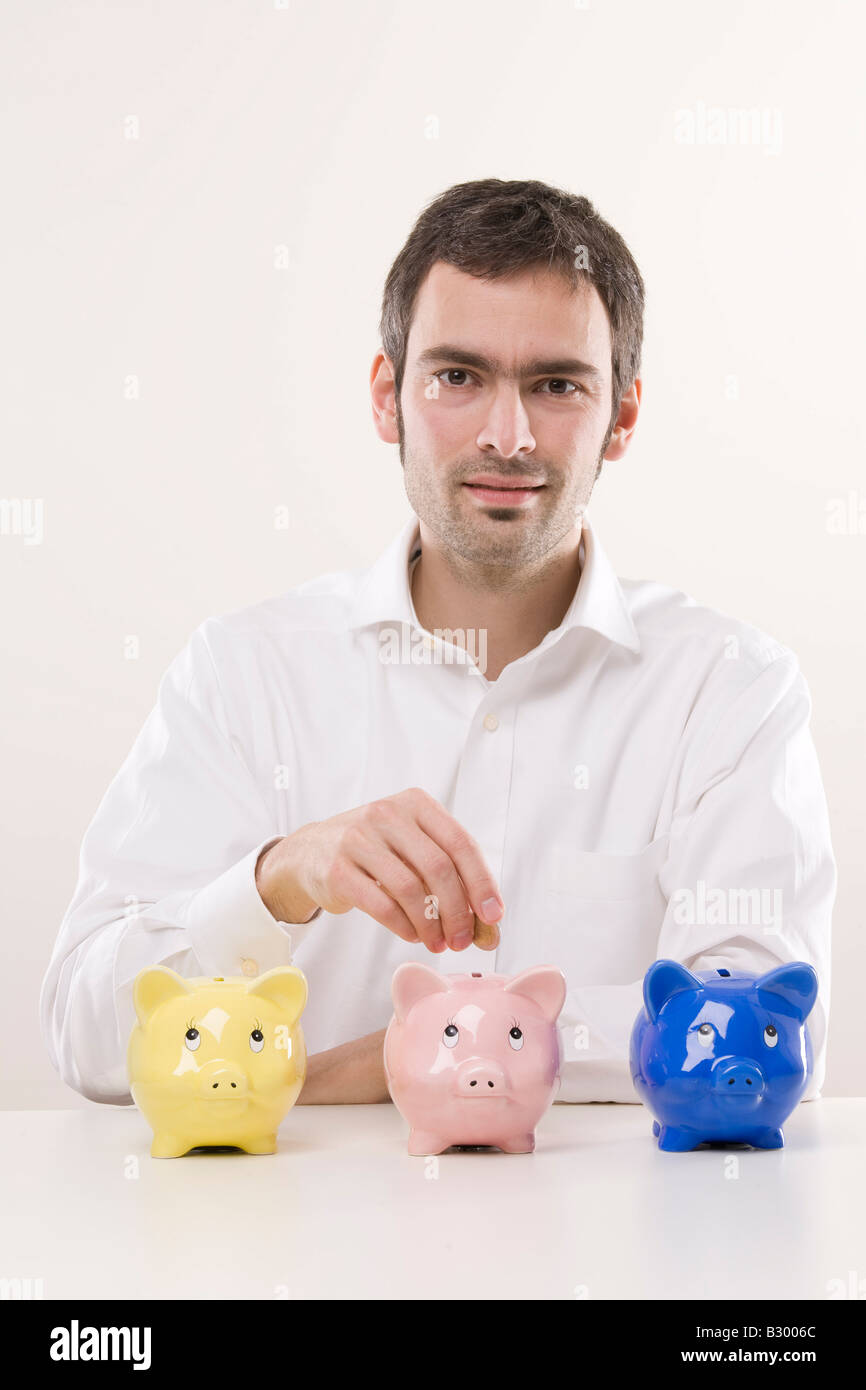 Man with Piggy Banks Stock Photo - Alamy