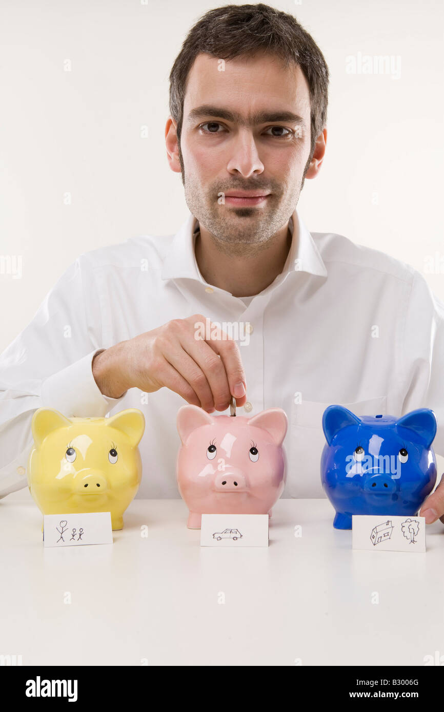 Man with Piggy Banks Stock Photo - Alamy