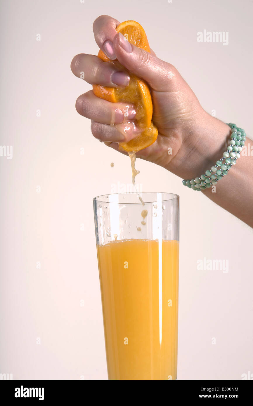 Woman Squeezing Orange, Making Orange Juice Stock Photo Alamy