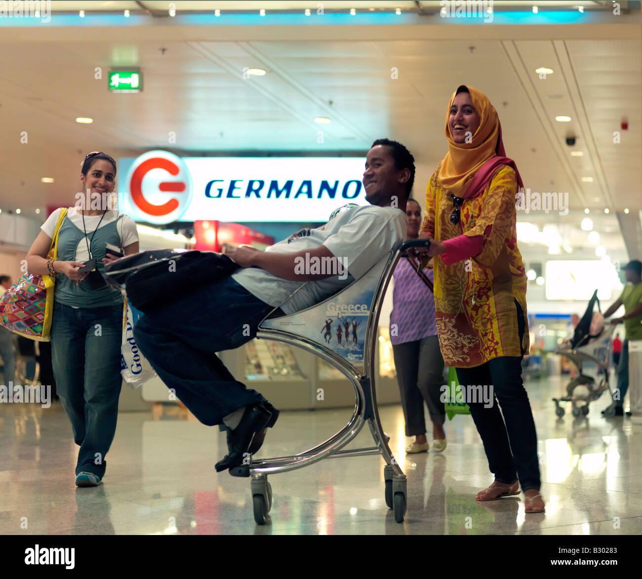Man being pushed in a luggage trolley Athens Airport Greece Stock Photo -  Alamy