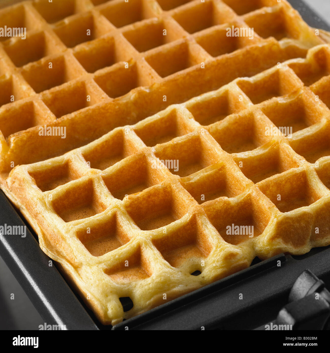 Waffles in Waffle Iron Stock Photo Alamy