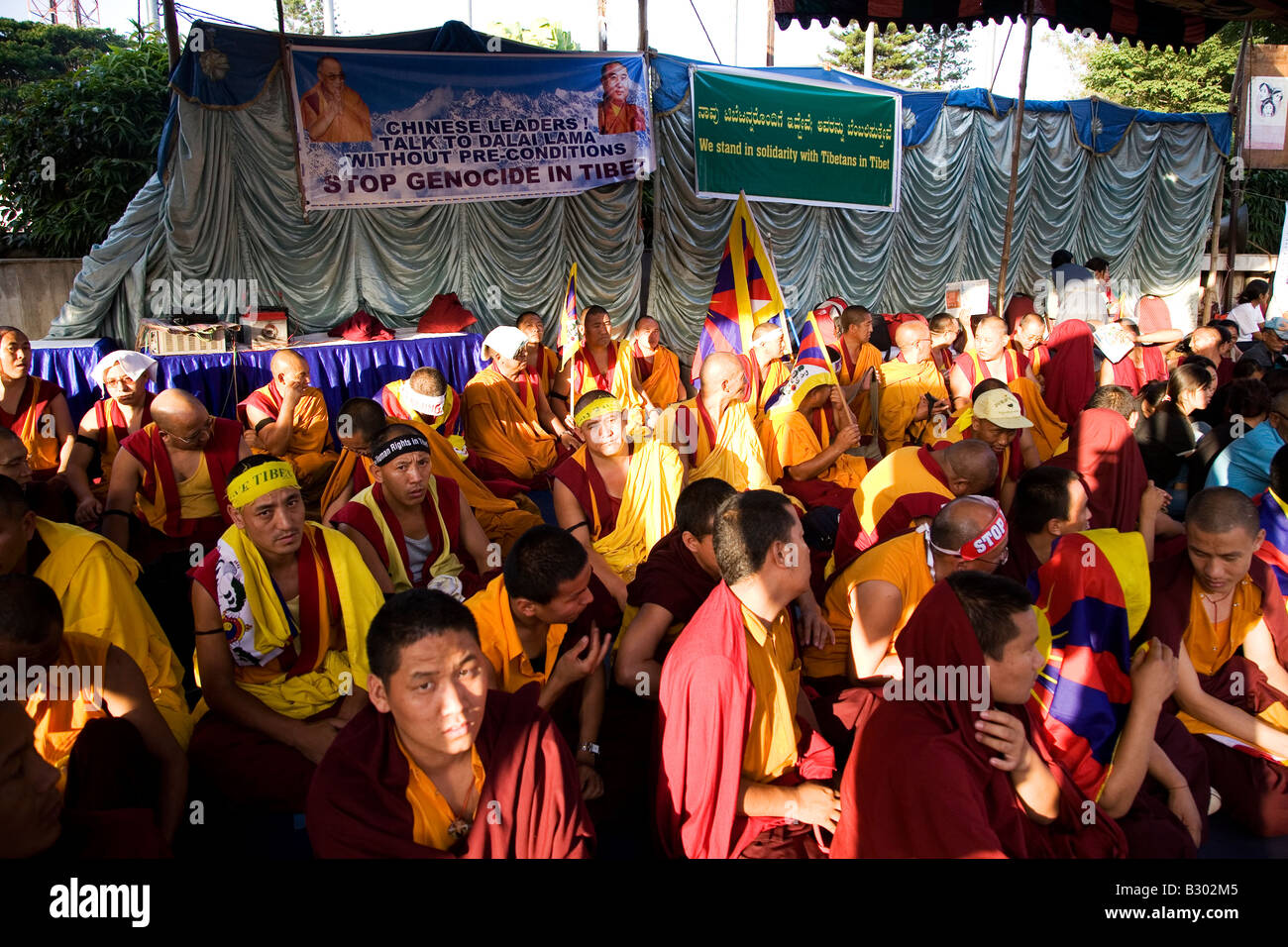Tibetan exiles and people of Tibetan origin protest under the shade of an awning in Bangalore. Stock Photo