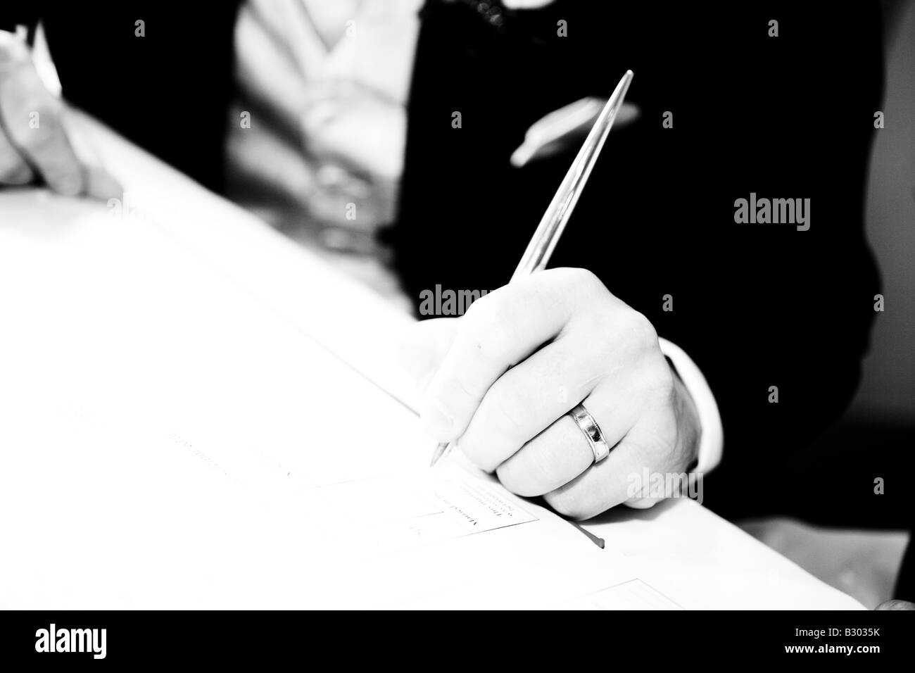 A groom signing the register. Stock Photo