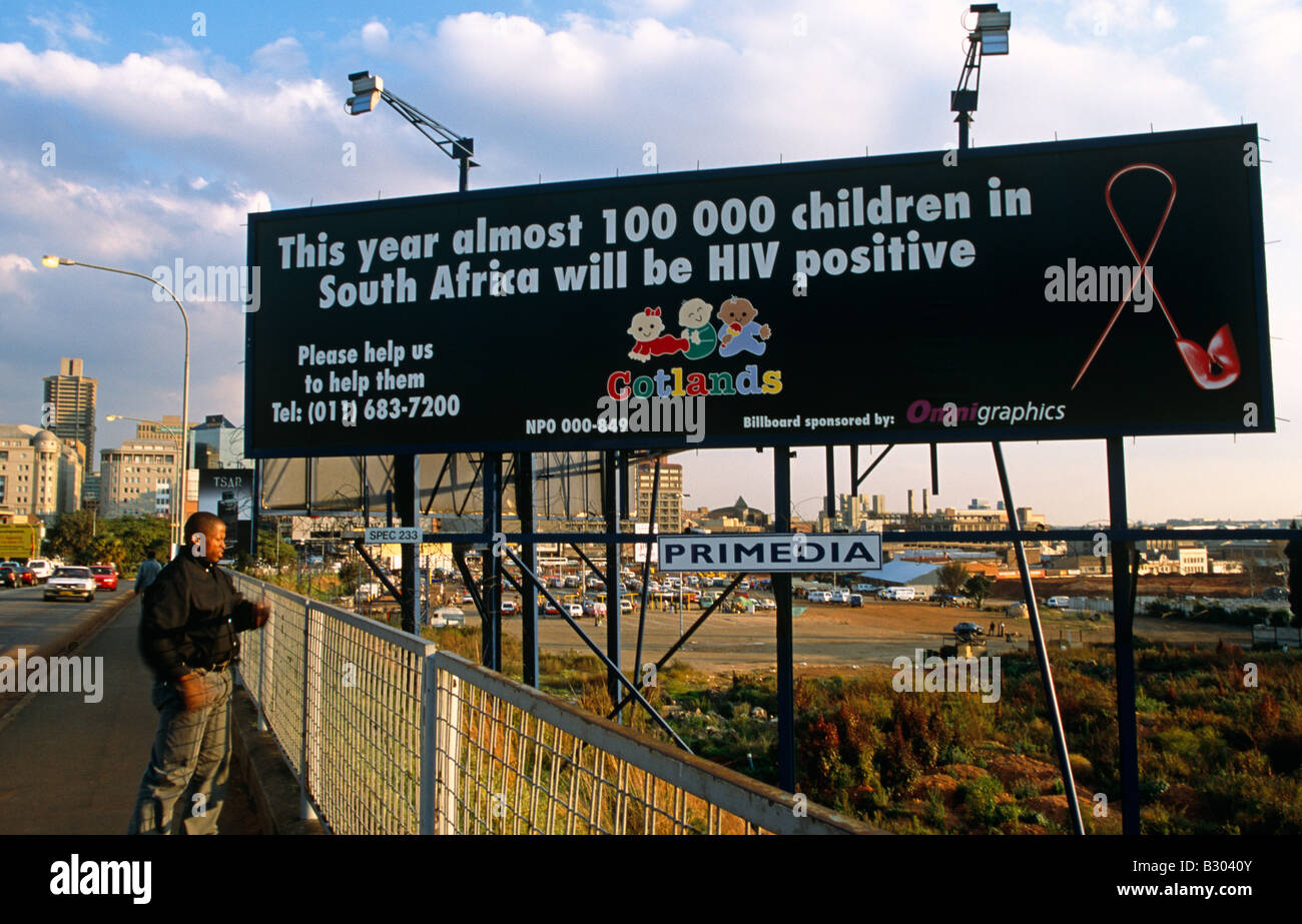 Man standing in front of AIDS awareness billboard. Johannesburg Stock