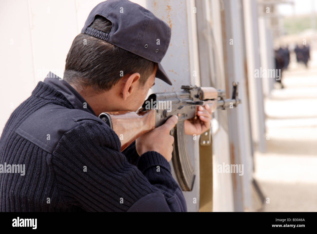Iraqi police officer aiming AK47 machine gun Stock Photo