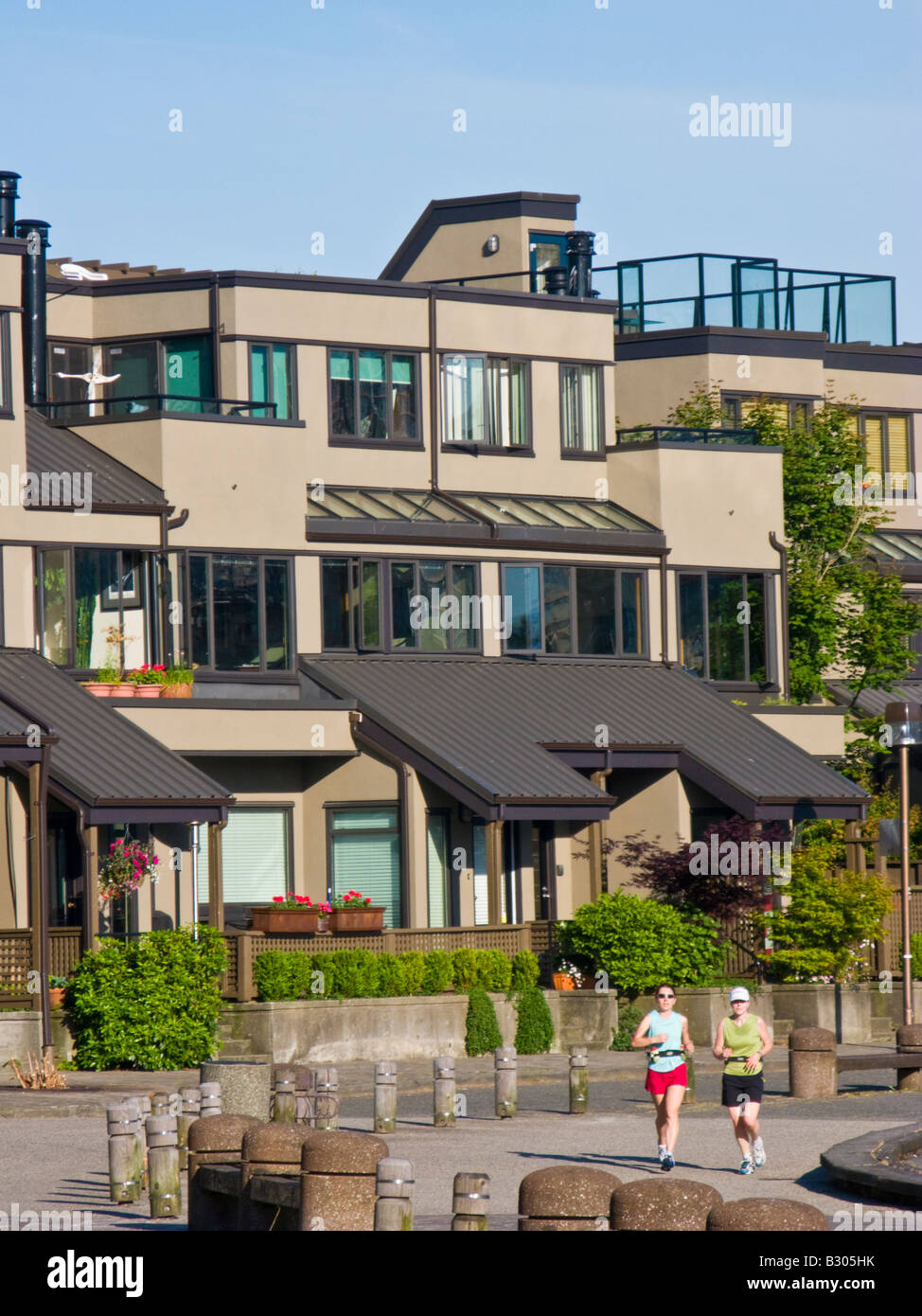 joggers and housing at Millbank, False Creek, Vancouver, British Columbia, Canada Stock Photo