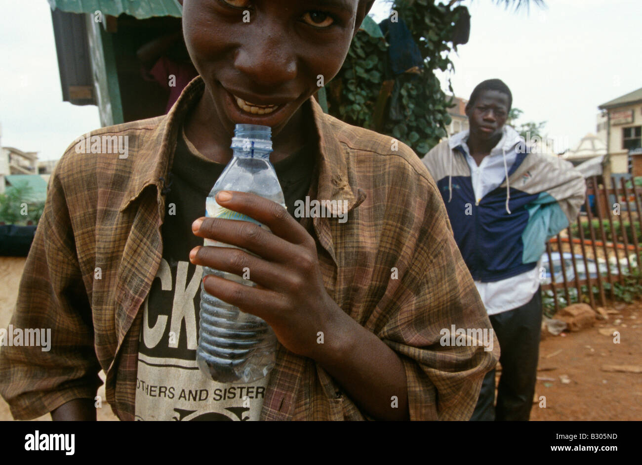 Street children sniffing glue in Kampala, Uganda. Stock Photo