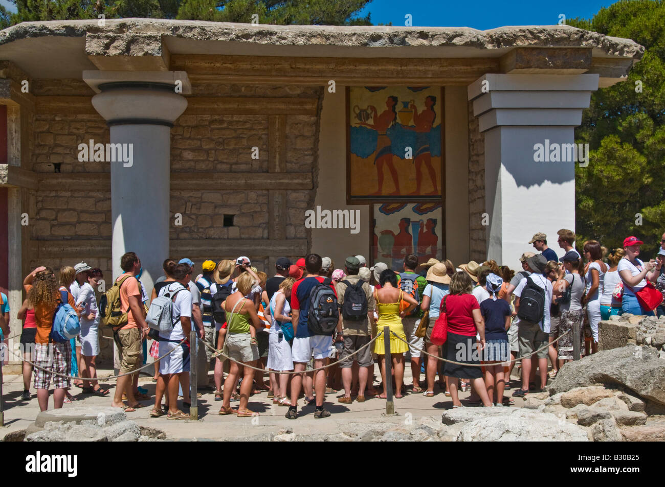Knossos, Crete, Greece. Minoan Archaeological Site. Procession Fresco (replica) Crowd of Visitors Stock Photo