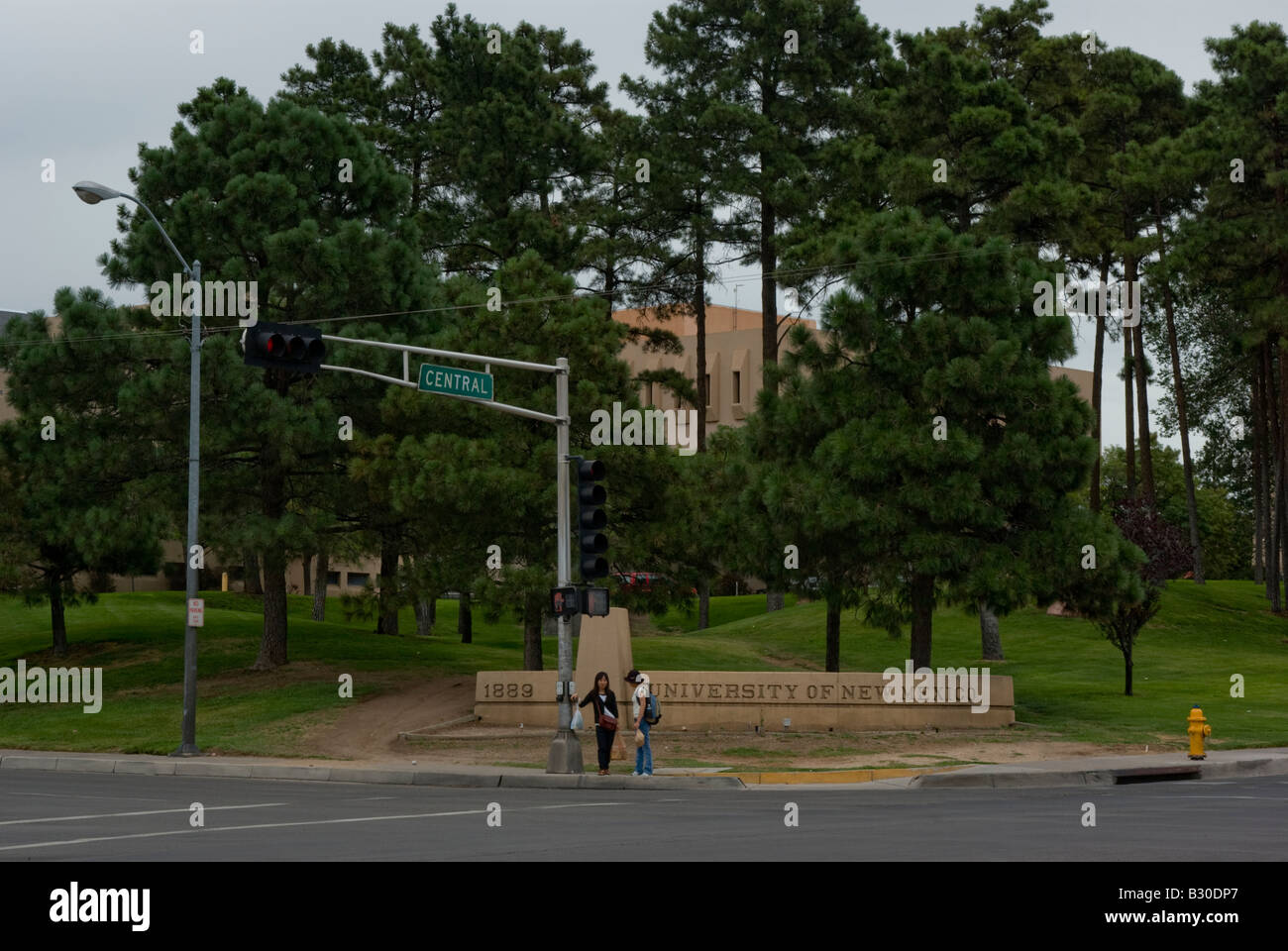 Two girls in front of the University of New Mexico sign in Albuquerque's Central Avenue Stock Photo