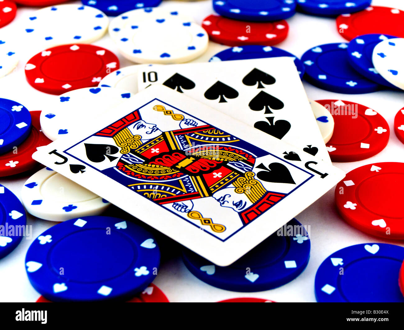 Red White and Blue Poker Chips and Black Jack on White Background Stock