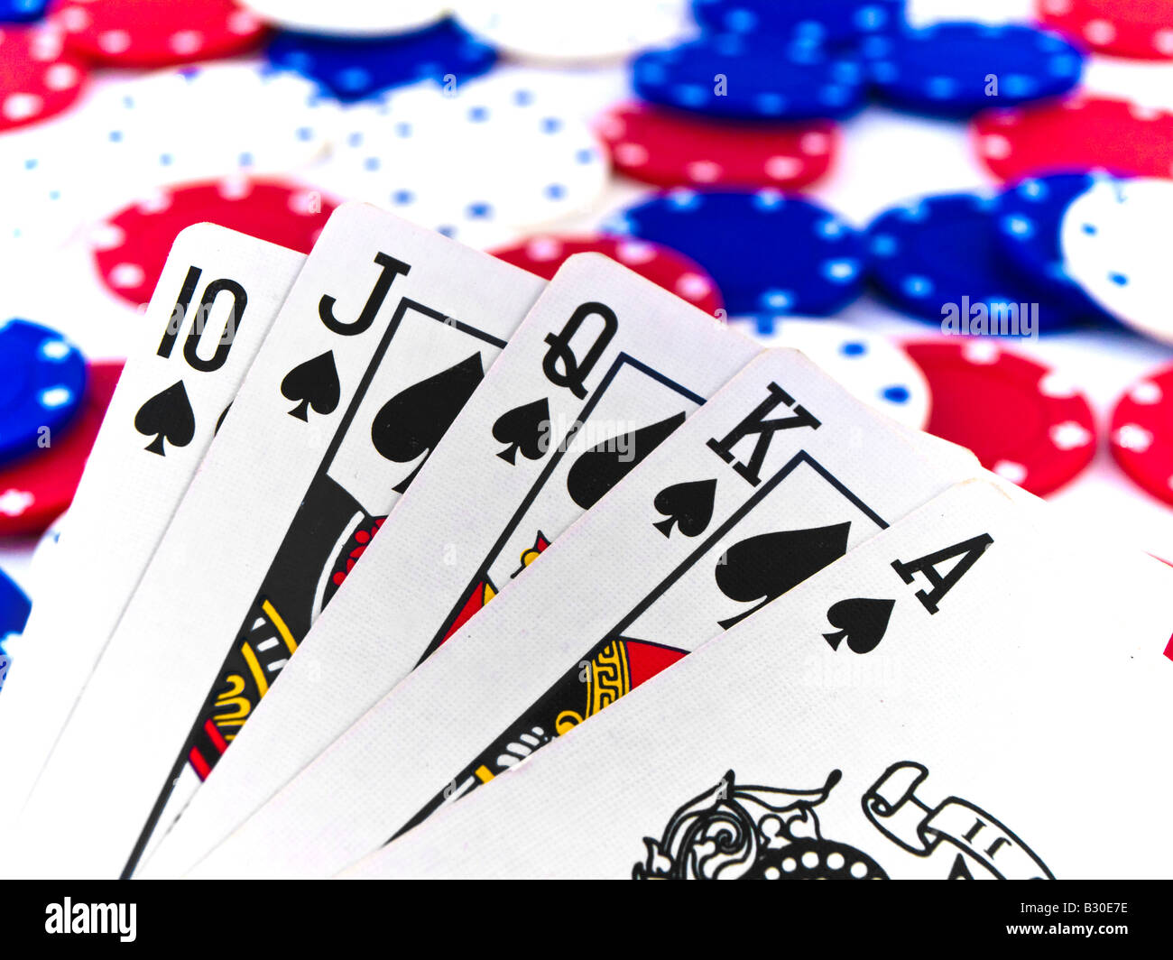 Red White and Blue Poker Chips and Royal Flush on White Background