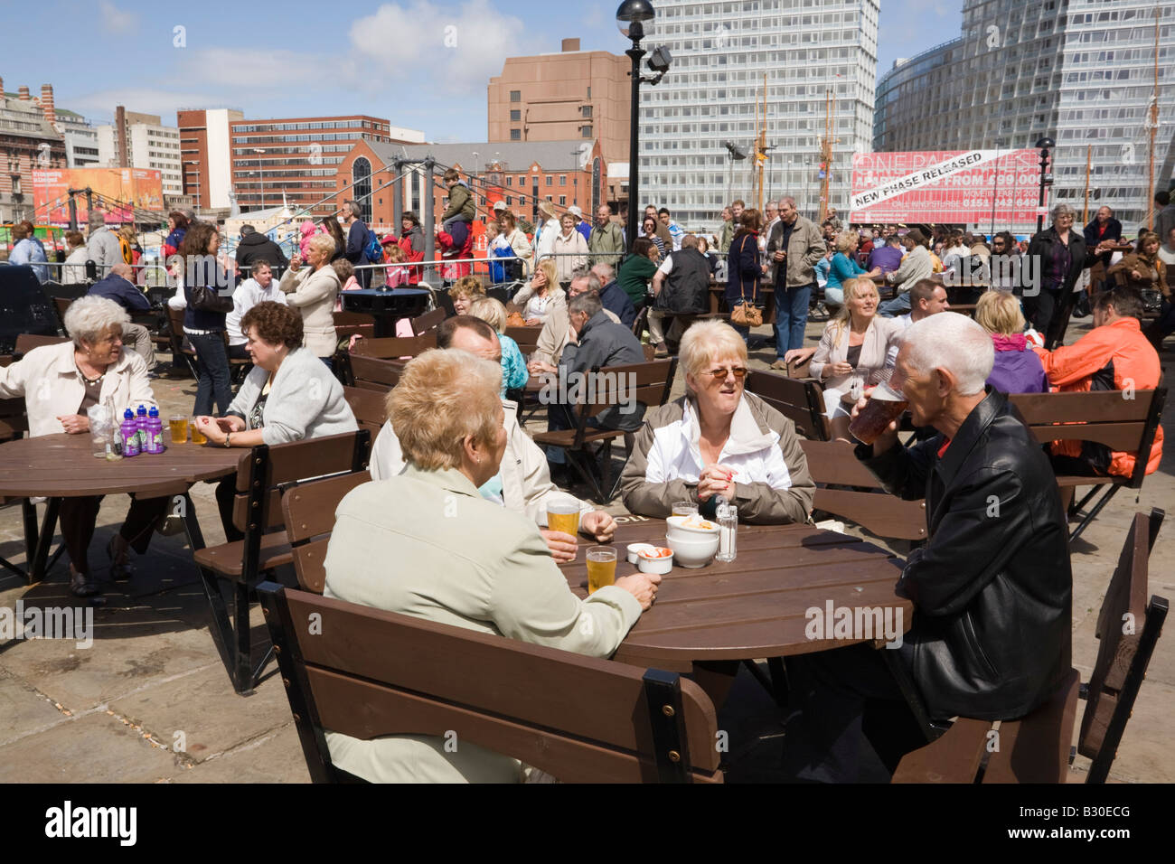 The Pumphouse pub with English people sitting drinking at outdoor tables in a busy beer garden in summer. Liverpool Merseyside England UK Britain Stock Photo