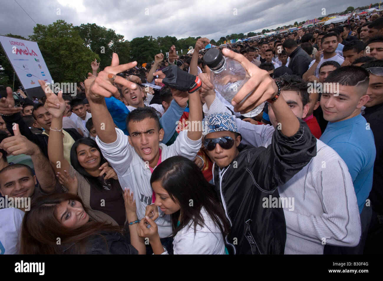 Asian youth during music festival at London Mela Festival at Gunnesbury Park Ealing London United Kingdom Stock Photo