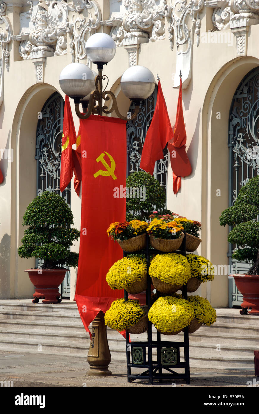 Communist party flag Hotel de Ville or People s Committee Building Saigon Vietnam Stock Photo