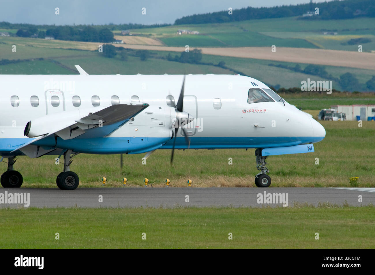 Saab SF 340B Turbo Prop Passenger Aircraft owned by Flybe operated by Loganair at Inverness Airport Stock Photo