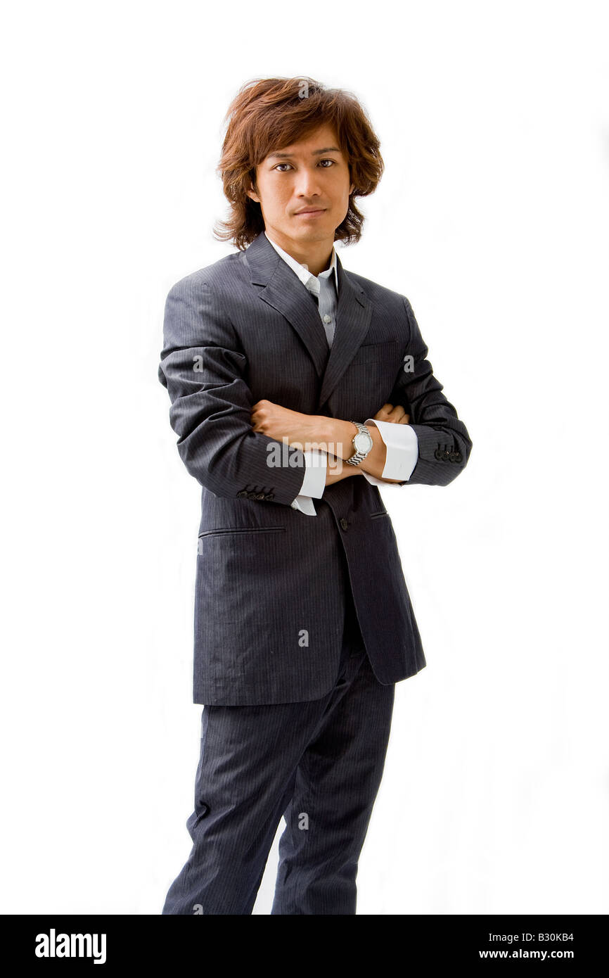Young Asian business man dressed in a gray pinstripe suit with arms crossed isolated Stock Photo
