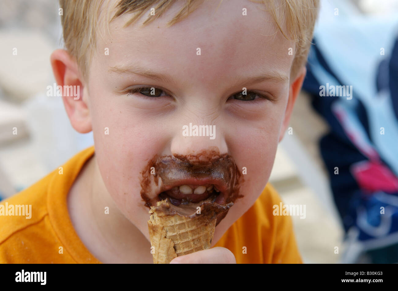 A young boy eating a chocolate ice cream Stock Photo Alamy