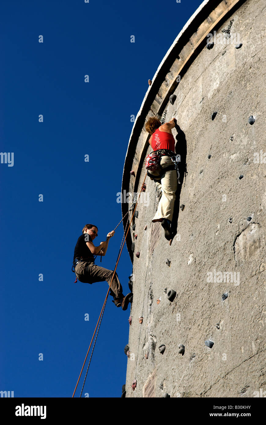 Two people climbing up a wall, Berlin, Germany Stock Photo Alamy