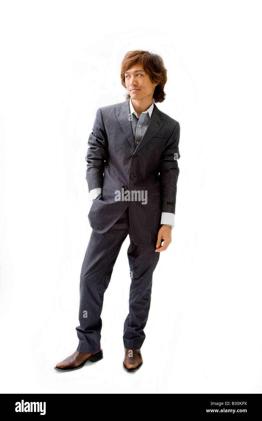 Young Asian business man dressed in a gray pinstripe suit with hand in pocket isolated Stock Photo