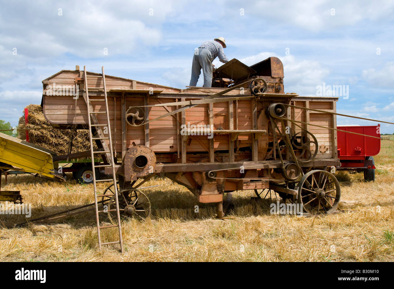 French farmer checking old thresher at agricultural show, Indre, France. Stock Photo