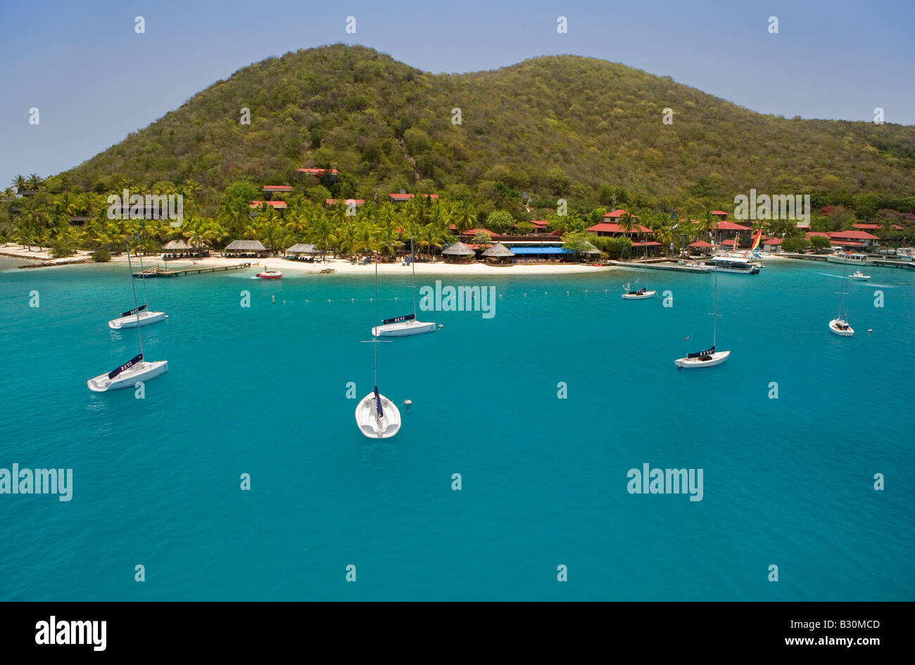 Class sailboats moored in front of The Bitter End Yacht Club on Virgin Gorda s North coast Stock Photo