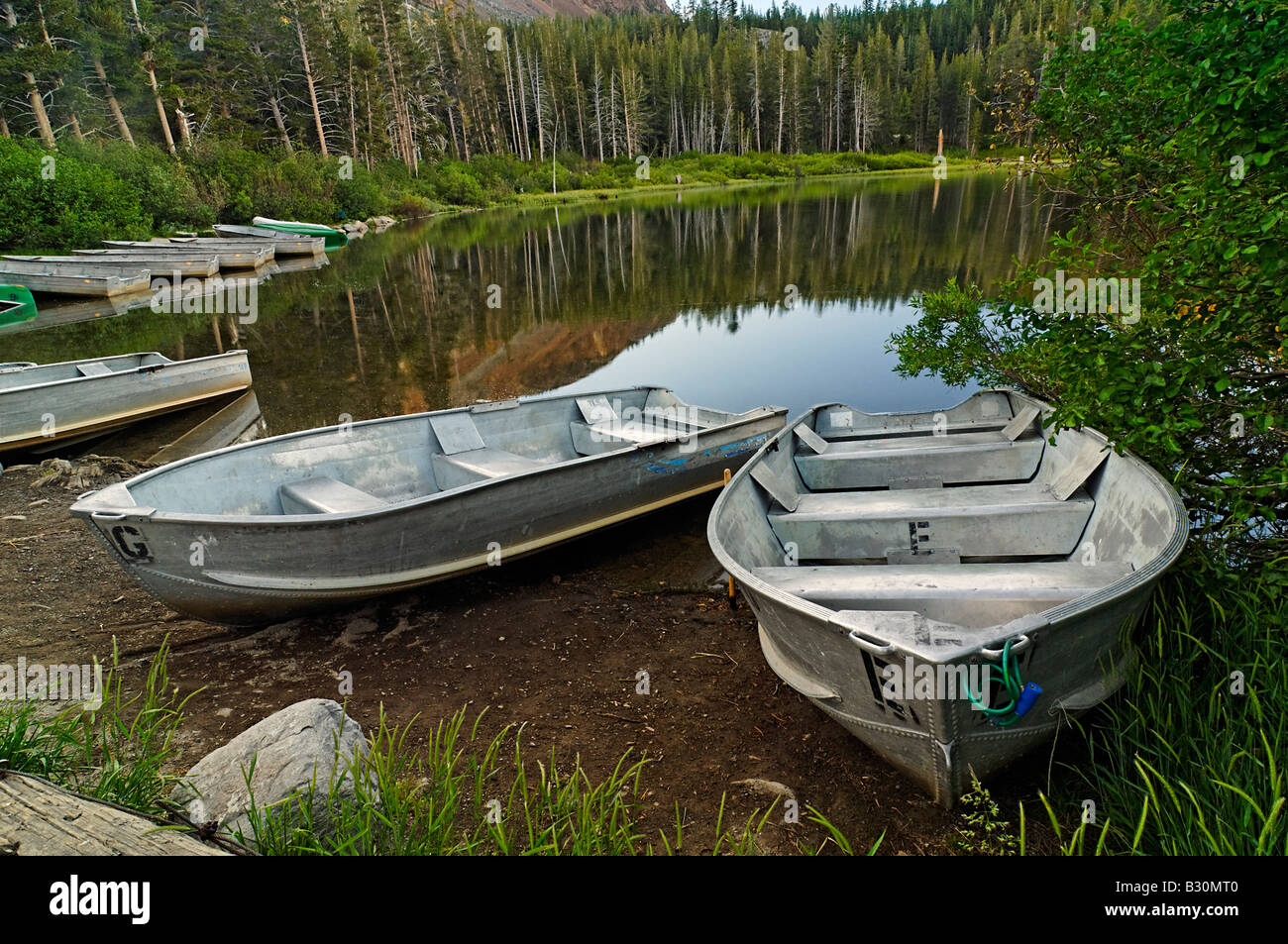 Row Boats lining a lake Stock Photo