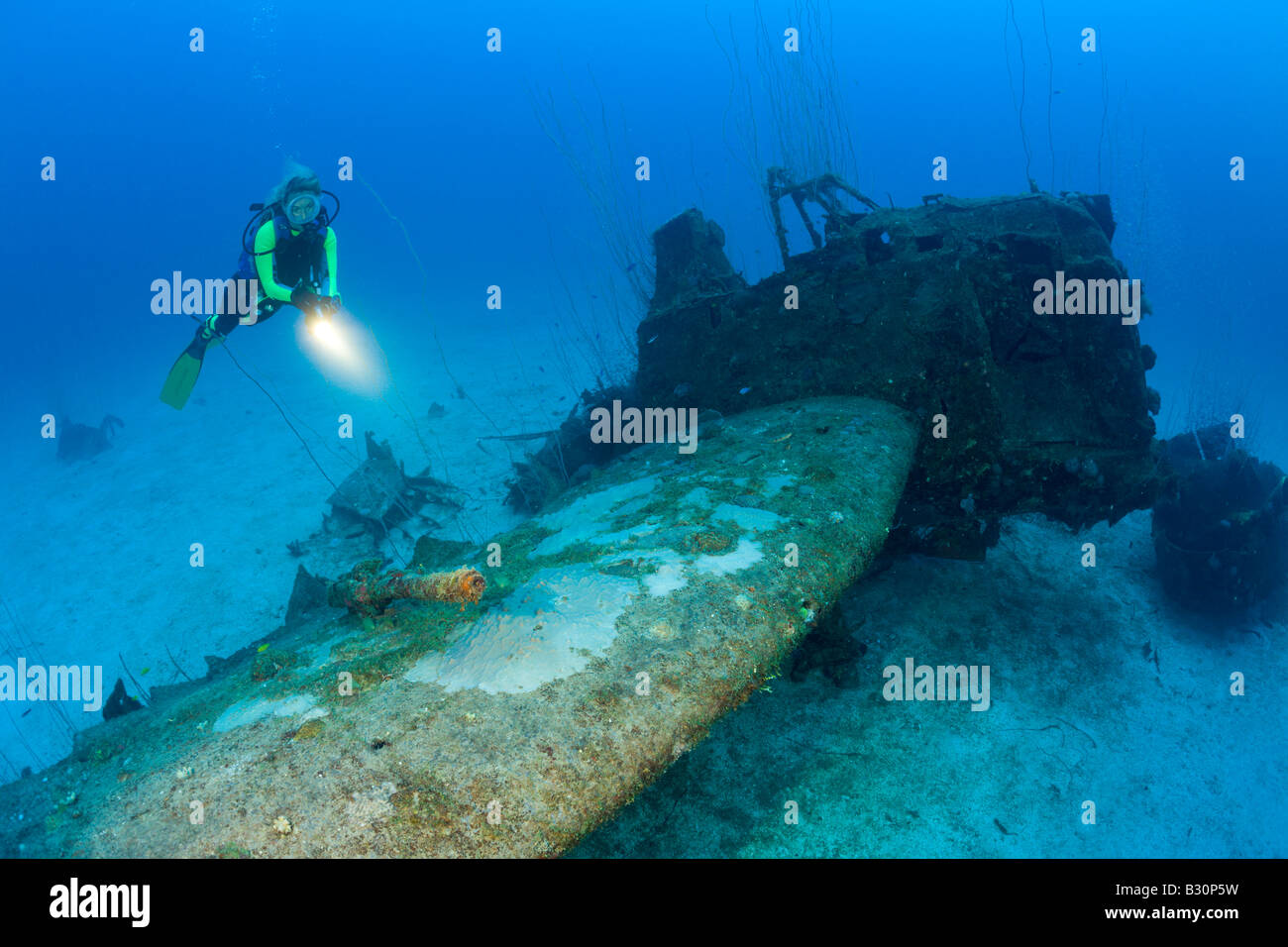 Diver and anti aricraft armament at Bomber near to USS Saratoga Marshall Islands Bikini Atoll Micronesia Pacific Ocean Stock Photo