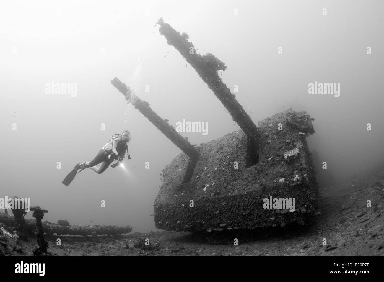 Diver and Twin 8 inch 55 caliber Gun on USS Saratoga Marshall Islands Bikini Atoll Micronesia Pacific Ocean Stock Photo