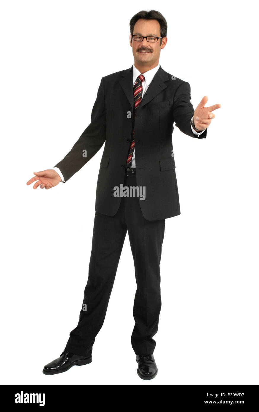 Man wearing suit with arms outstreched, looking in the camera Stock Photo